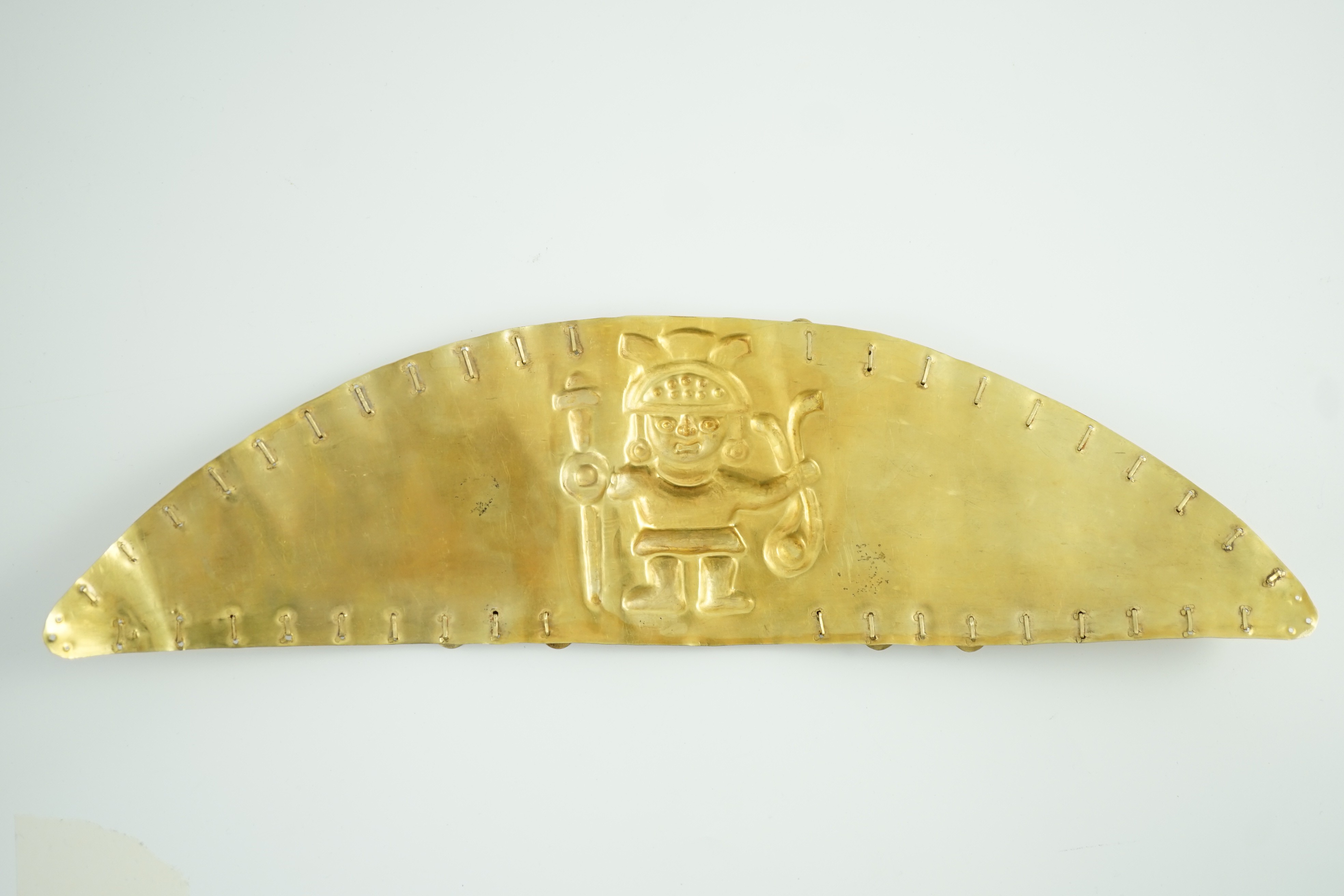 A rare pre-Columbian sheet gold headdress or breast plate, possibly Moche culture, Northern Peru, A.D. 200 - 850, 36cm wide 9.7cm high, weight 130g
